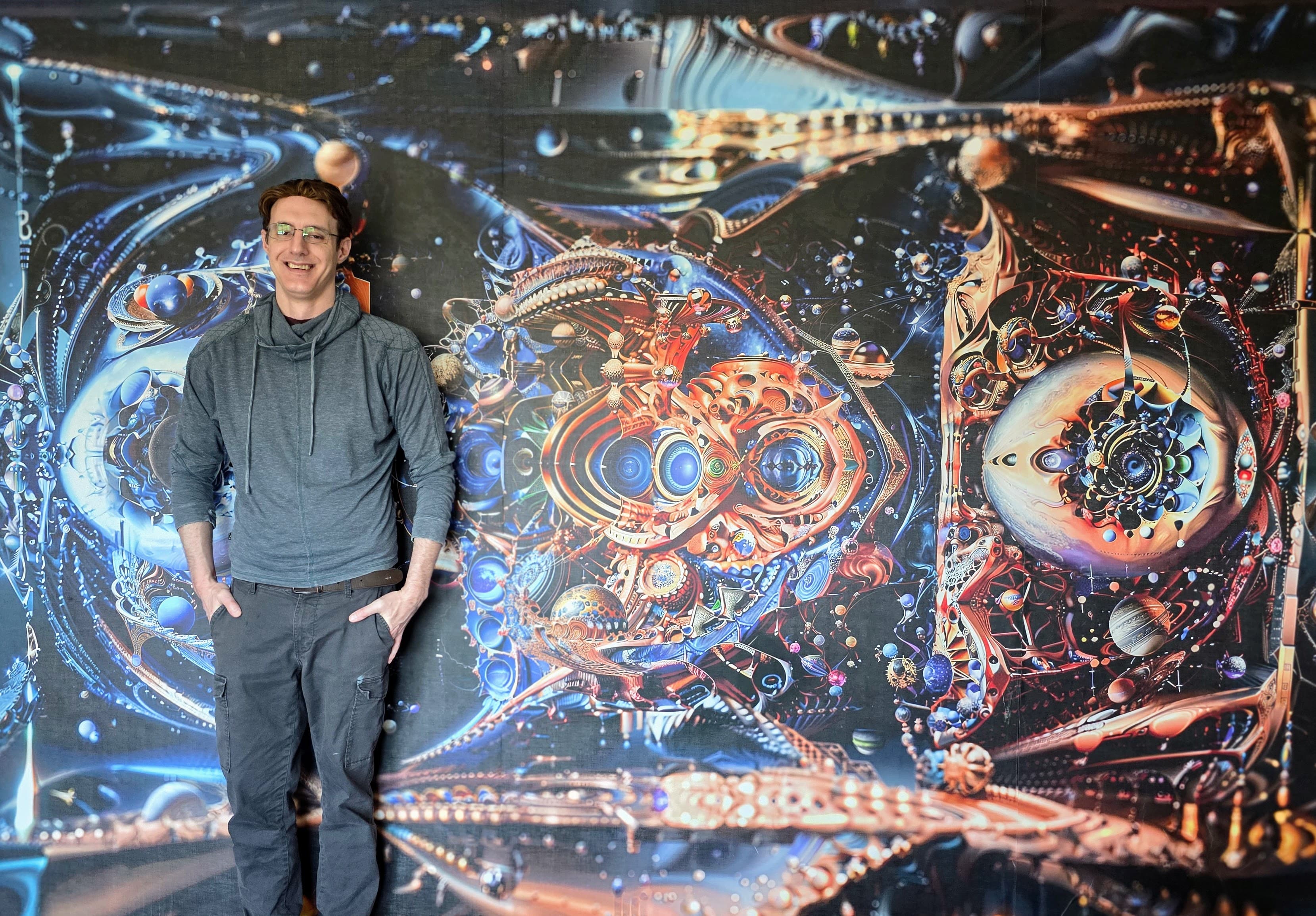 Callahan Indovina standing in front of one of his artworks